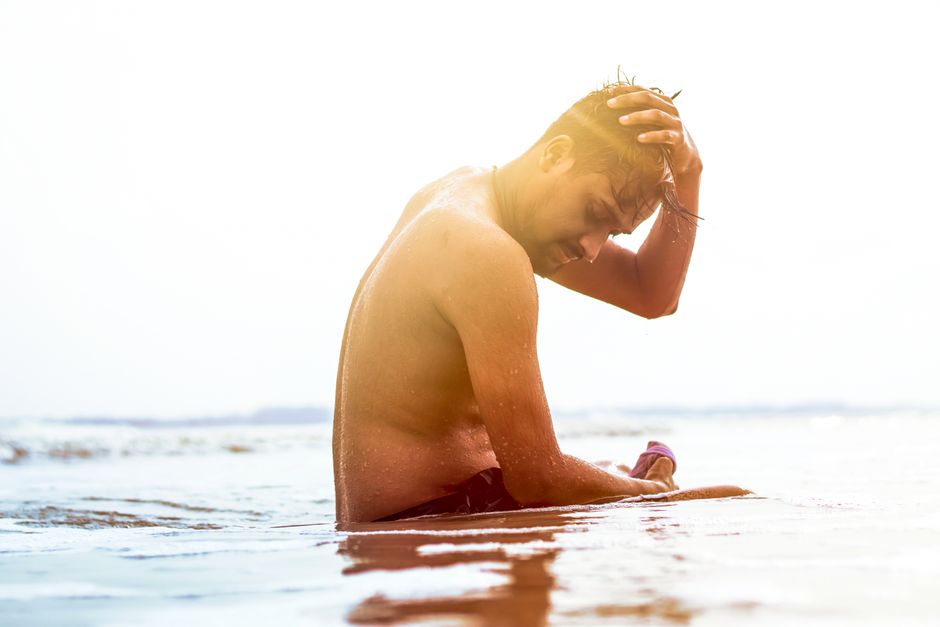 A man enjoys a peaceful moment during sunset on Baguran Jalpai beach, India.