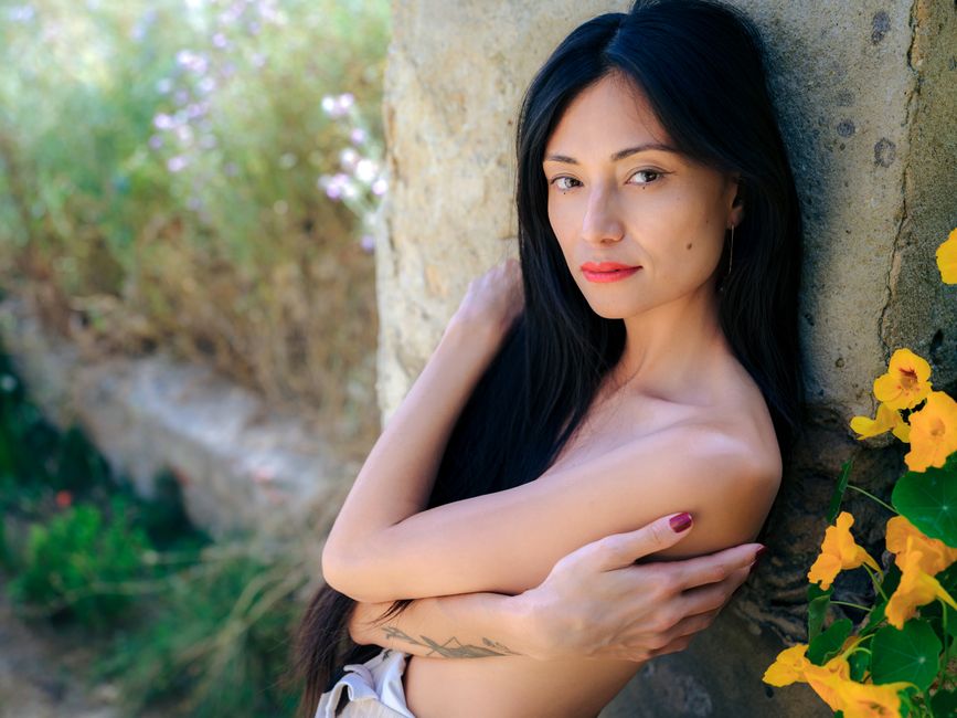 Beautiful portrait of a serene woman embracing nature in Lisbon, Portugal.