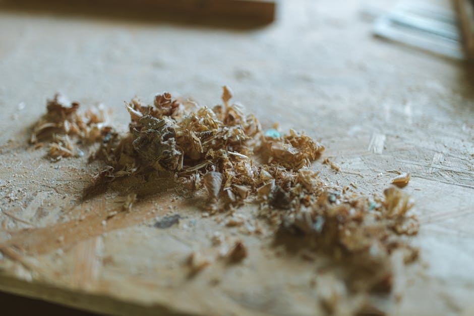 Detailed view of wood shavings and sawdust scattered across a wooden surface.