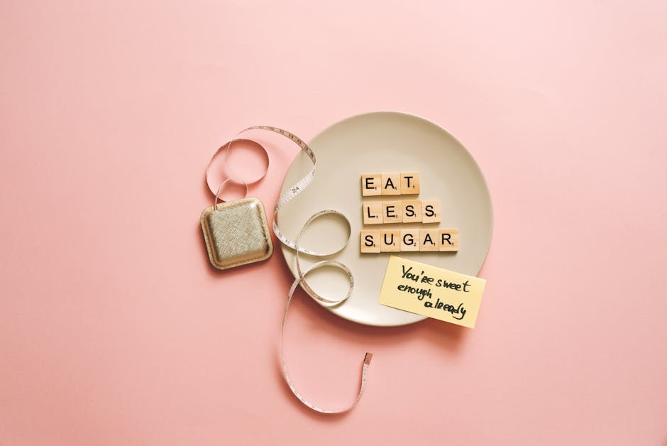 Flat lay of letter tiles on plate with measuring tape, promoting health message to eat less sugar.