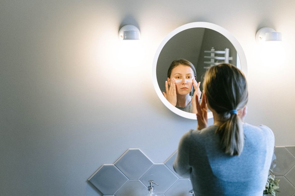 Woman applying face cream during a skincare routine